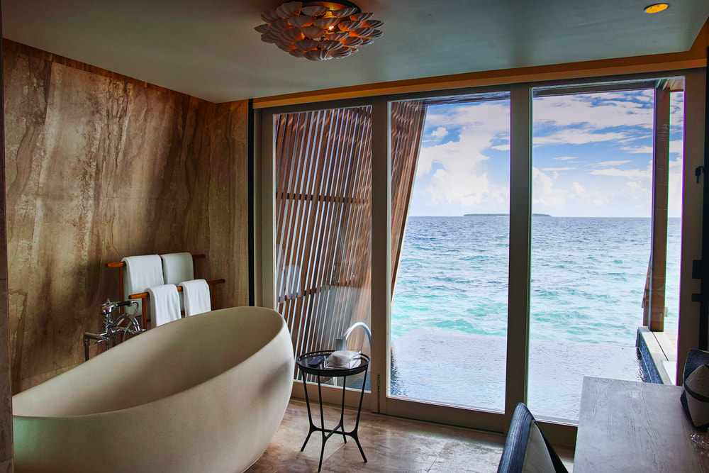 luxury resort tub and view of sea